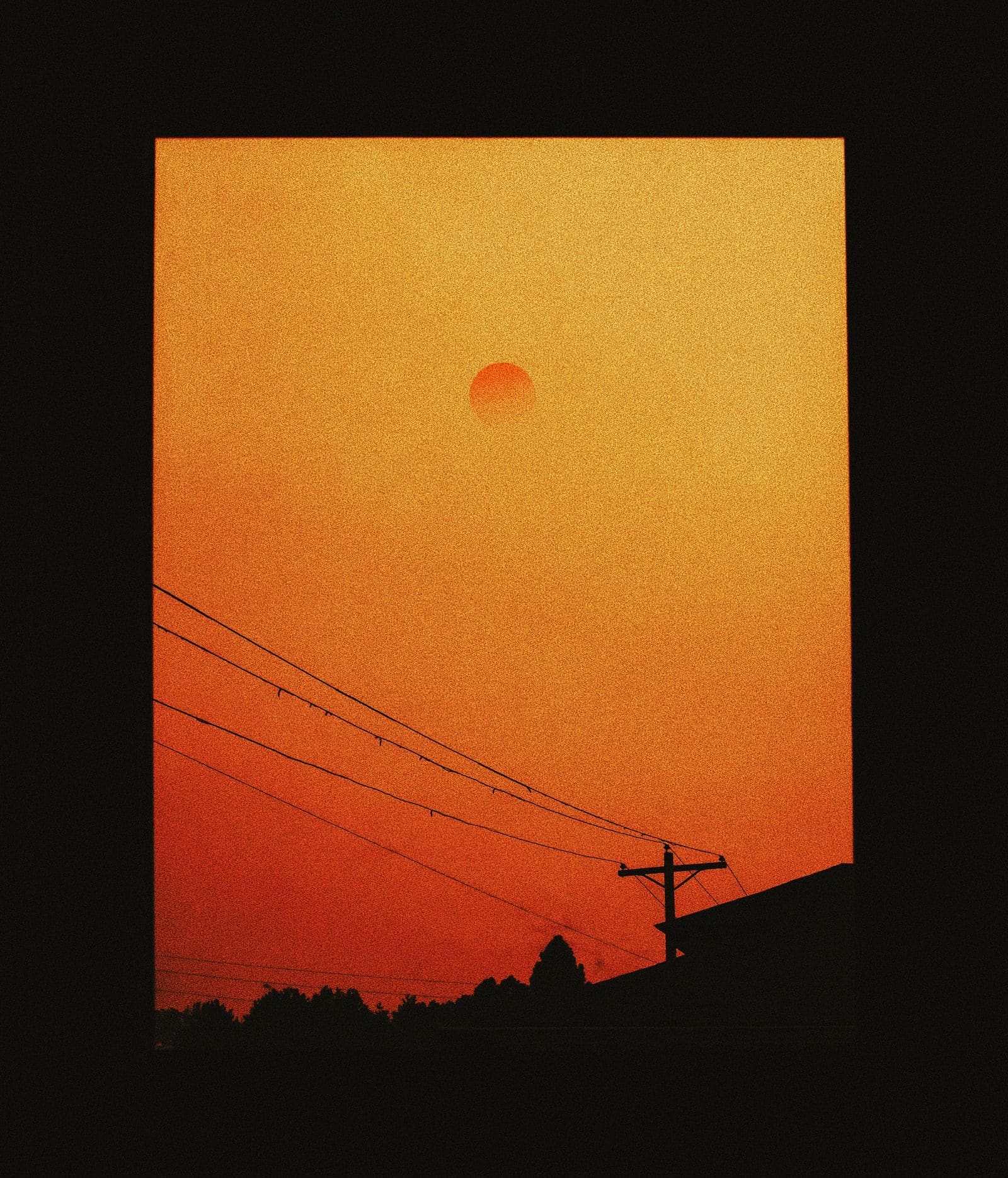 Orange wildfire smoke haze seen through a window
